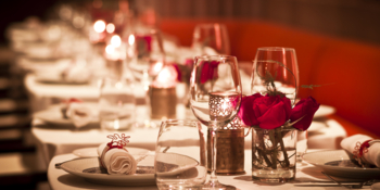 Couple toasting champagne flutes in restaurant 
